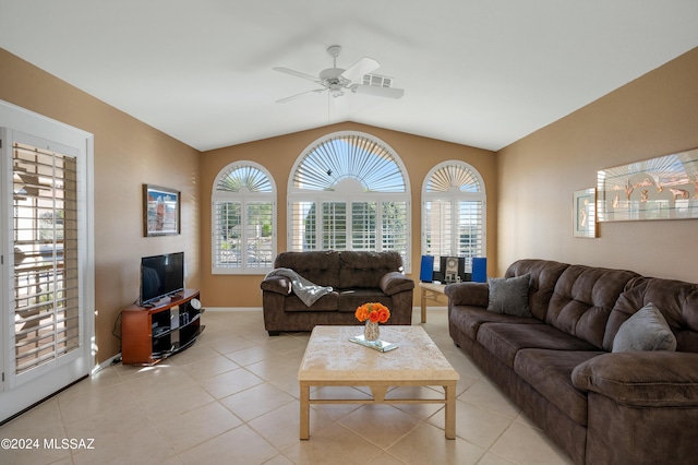 living area featuring plenty of natural light, visible vents, vaulted ceiling, and light tile patterned floors