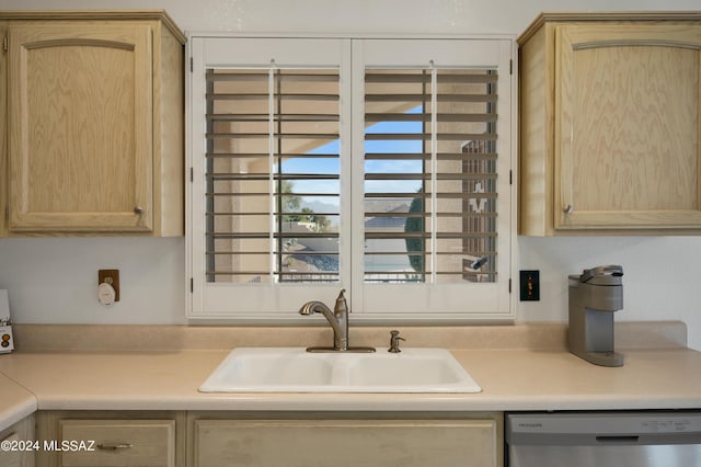 kitchen with a sink, light countertops, dishwasher, and light brown cabinetry