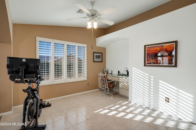 exercise area featuring light tile patterned floors, visible vents, vaulted ceiling, ceiling fan, and baseboards