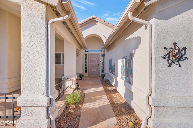 entrance to property featuring stucco siding