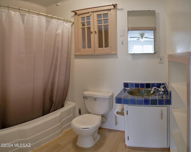 full bathroom with vanity, toilet, hardwood / wood-style floors, and shower / bath combo with shower curtain