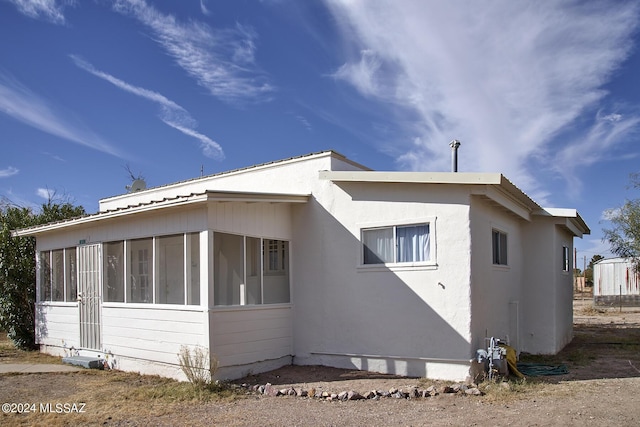 view of side of property featuring a sunroom