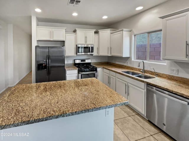 kitchen with a kitchen island, white cabinetry, appliances with stainless steel finishes, and sink