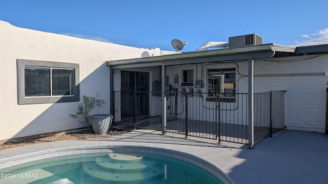 rear view of house with cooling unit and a patio area