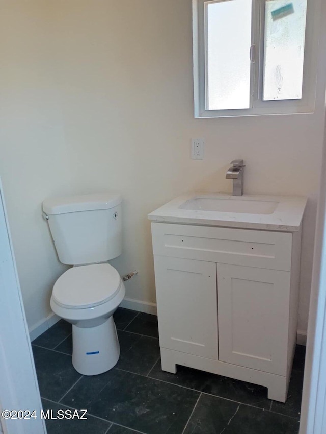 bathroom featuring tile patterned floors, vanity, and toilet