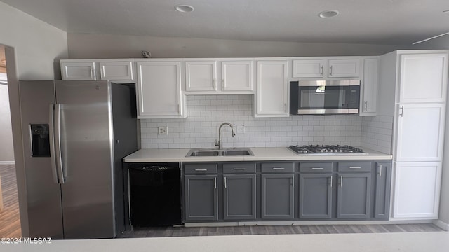 kitchen with white cabinetry, sink, gray cabinetry, decorative backsplash, and stainless steel appliances