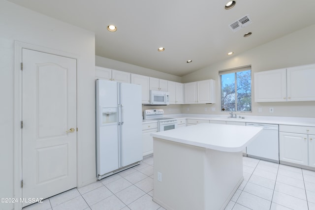 kitchen with white appliances, white cabinets, a center island, lofted ceiling, and light tile patterned flooring