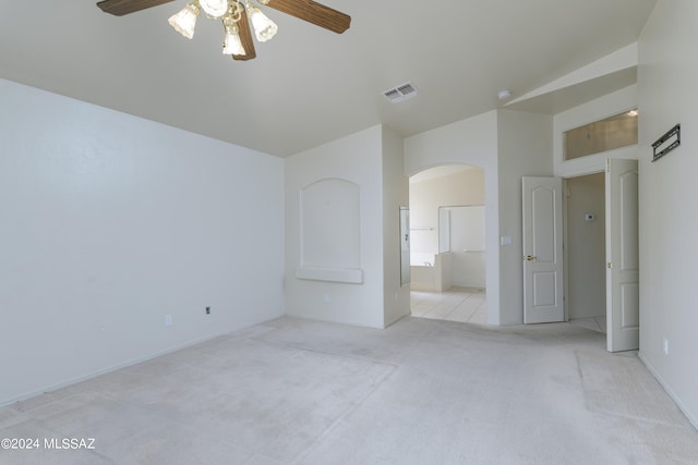 unfurnished bedroom featuring ceiling fan, ensuite bathroom, and light carpet