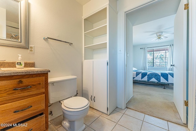 bathroom featuring ceiling fan, vanity, toilet, and tile patterned flooring