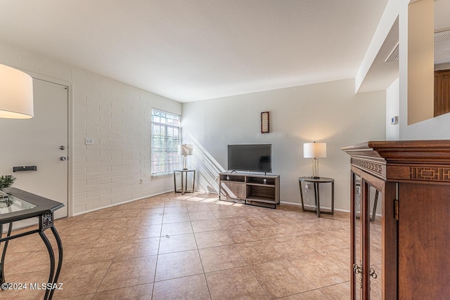 tiled living room with brick wall