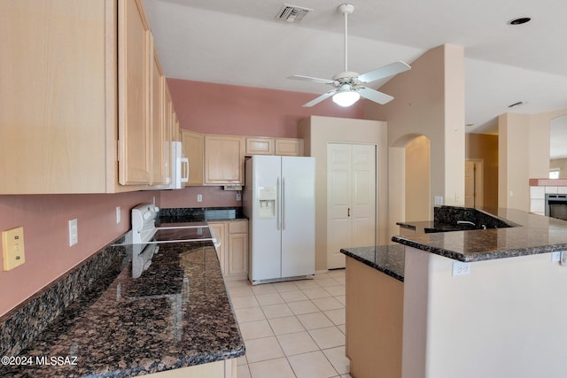 kitchen with light brown cabinets, white appliances, ceiling fan, and dark stone counters