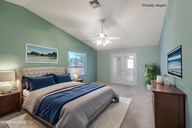 carpeted bedroom with french doors, ceiling fan, and vaulted ceiling