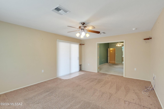 spare room featuring ceiling fan and light carpet