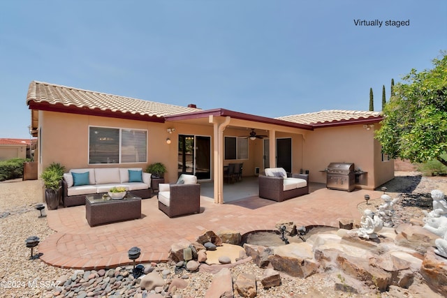 rear view of property featuring outdoor lounge area, ceiling fan, and a patio area