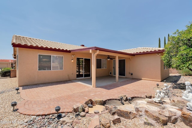 rear view of property with a patio area and ceiling fan