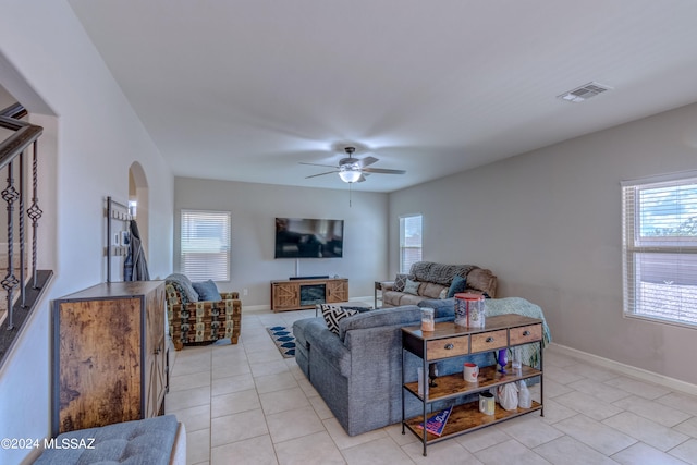 living room with ceiling fan and light tile patterned flooring