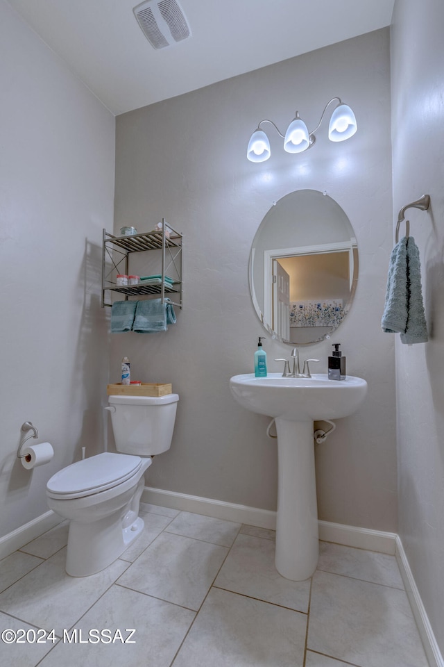 bathroom featuring tile patterned flooring and toilet