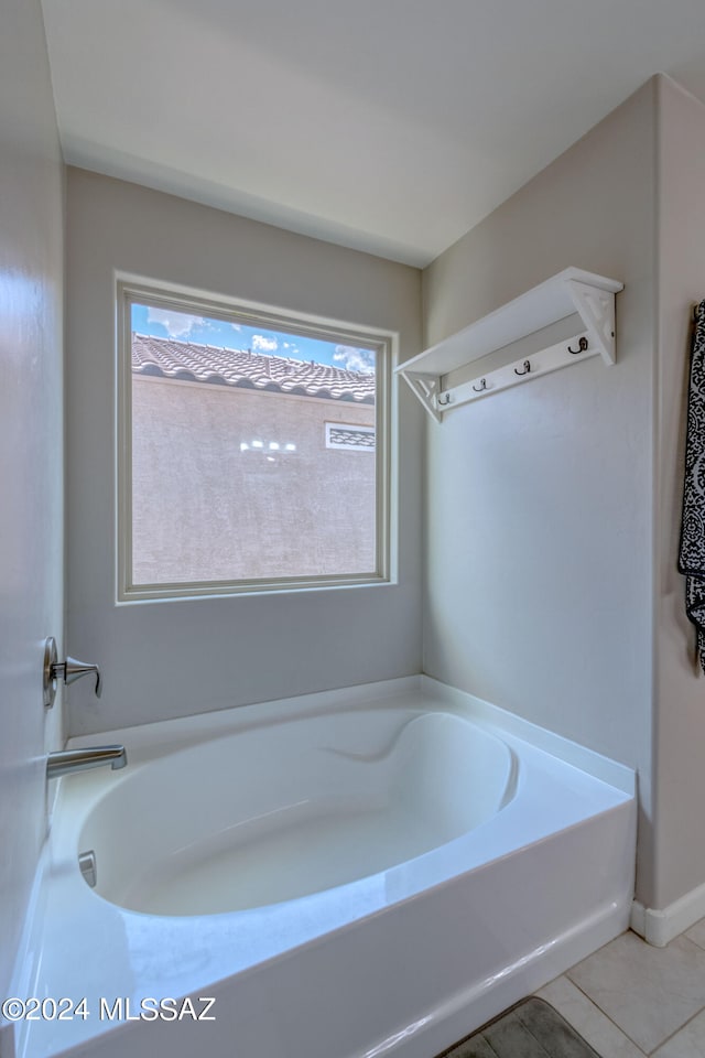 bathroom with tile patterned floors and a bathtub