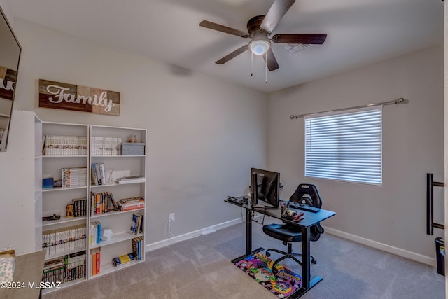 carpeted home office with ceiling fan