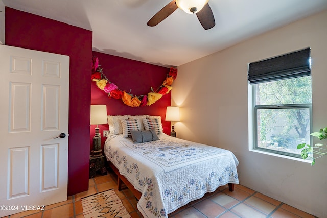 tiled bedroom featuring ceiling fan