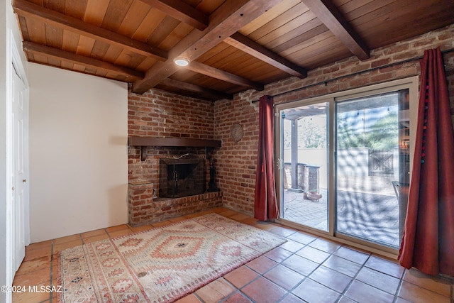 unfurnished living room with a fireplace, beam ceiling, light tile patterned floors, and wood ceiling