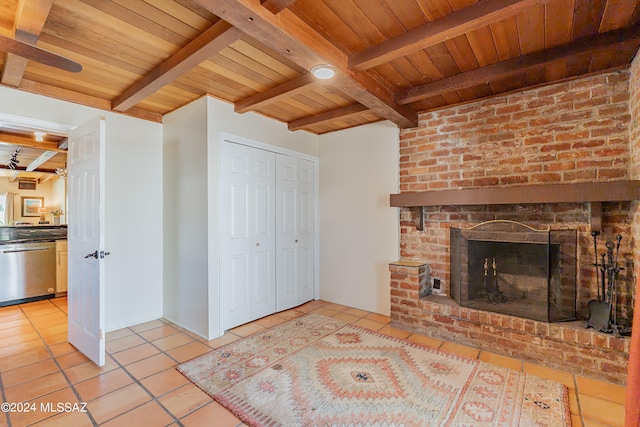 living room with wood ceiling, a fireplace, light tile patterned floors, and beamed ceiling