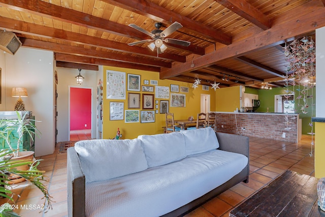 living room featuring wooden ceiling, beamed ceiling, tile patterned flooring, ceiling fan, and rail lighting