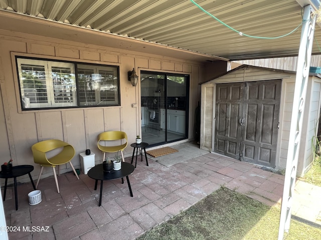 view of patio / terrace featuring a storage unit