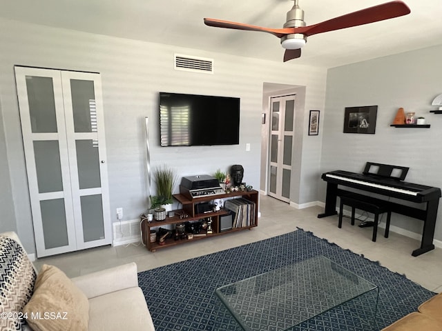 tiled living room featuring ceiling fan