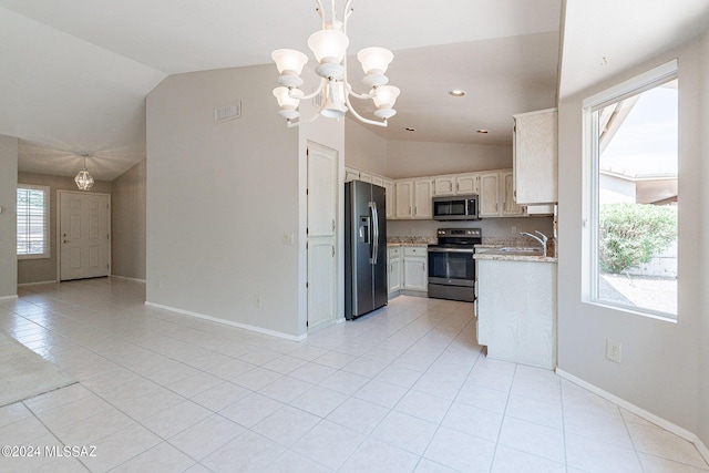 kitchen with vaulted ceiling, pendant lighting, white cabinets, a notable chandelier, and stainless steel appliances