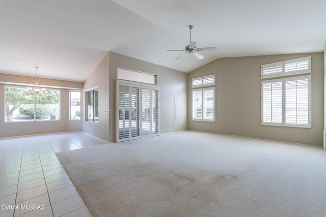 tiled spare room with vaulted ceiling and ceiling fan