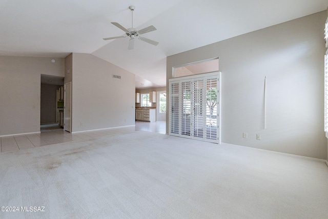 unfurnished living room with light carpet, high vaulted ceiling, and ceiling fan