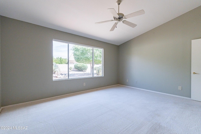 carpeted empty room featuring vaulted ceiling and ceiling fan