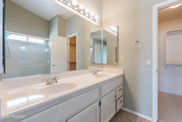 bathroom featuring walk in shower, tile patterned floors, and vanity