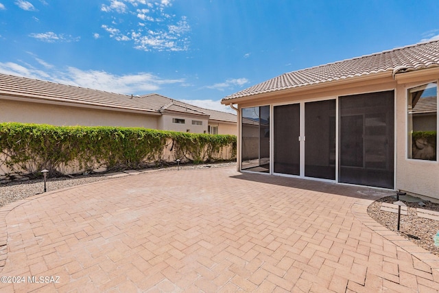 view of patio / terrace with a sunroom