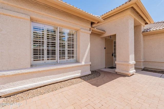 entrance to property featuring a patio