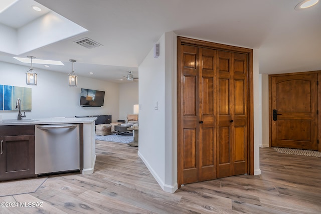 kitchen with decorative light fixtures, ceiling fan, sink, dishwasher, and light hardwood / wood-style floors