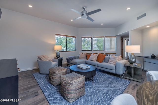 living room with dark wood-type flooring and ceiling fan