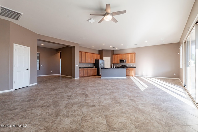 unfurnished living room with ceiling fan