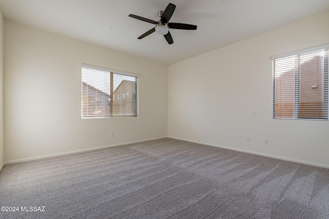 carpeted empty room featuring ceiling fan