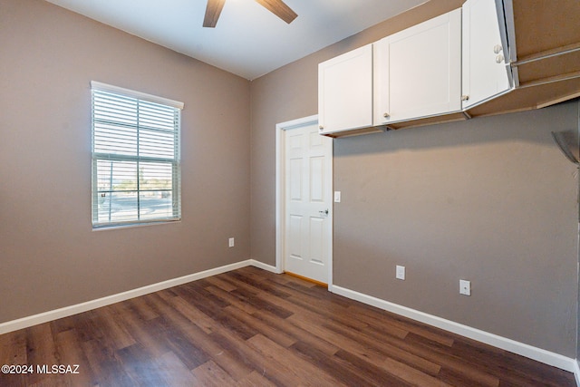 spare room featuring ceiling fan and dark hardwood / wood-style floors