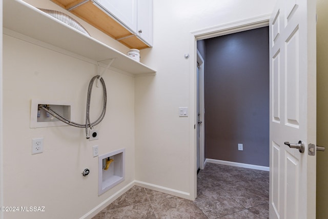 washroom with cabinets, hookup for a washing machine, and light tile patterned floors