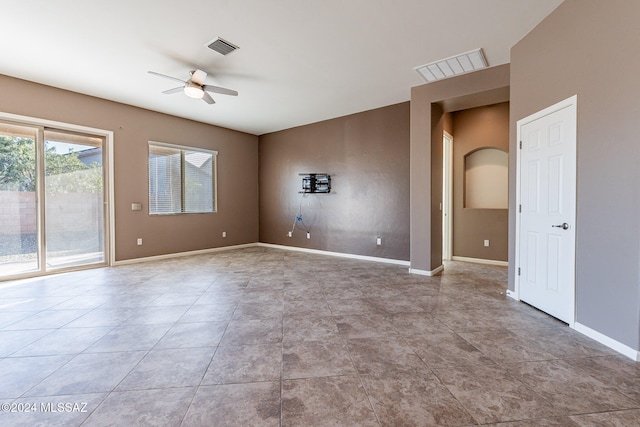 unfurnished room with ceiling fan and light tile patterned floors