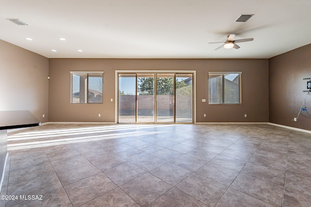 unfurnished room featuring ceiling fan and light tile patterned floors