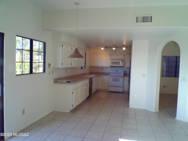 kitchen featuring white cabinetry, white appliances, track lighting, and light tile patterned floors