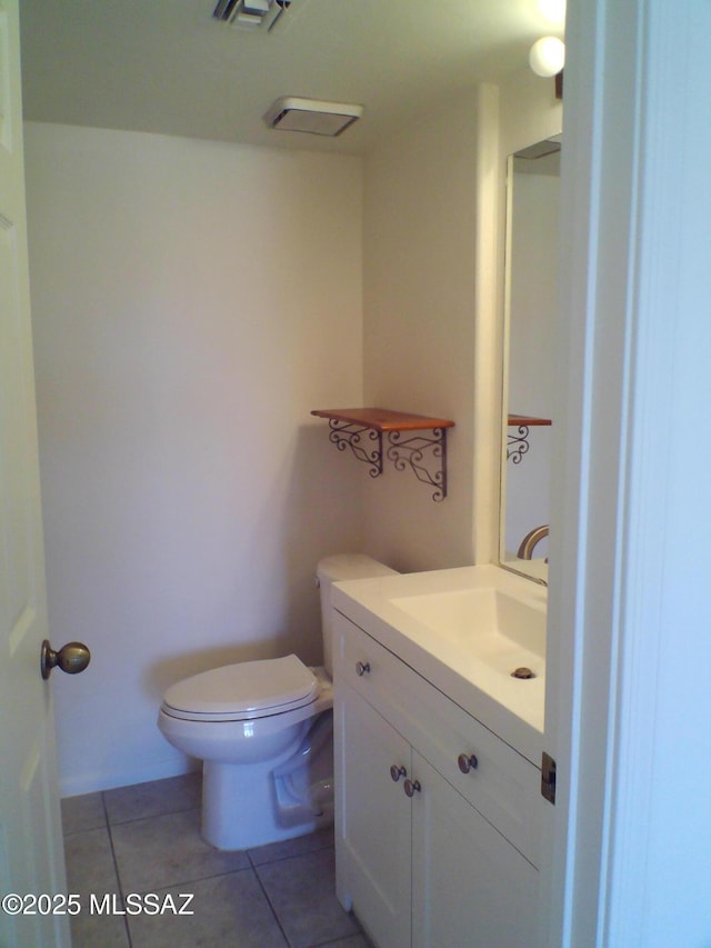 bathroom featuring vanity, tile patterned flooring, and toilet