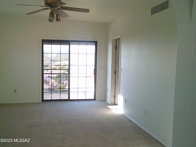 empty room with ceiling fan and carpet floors