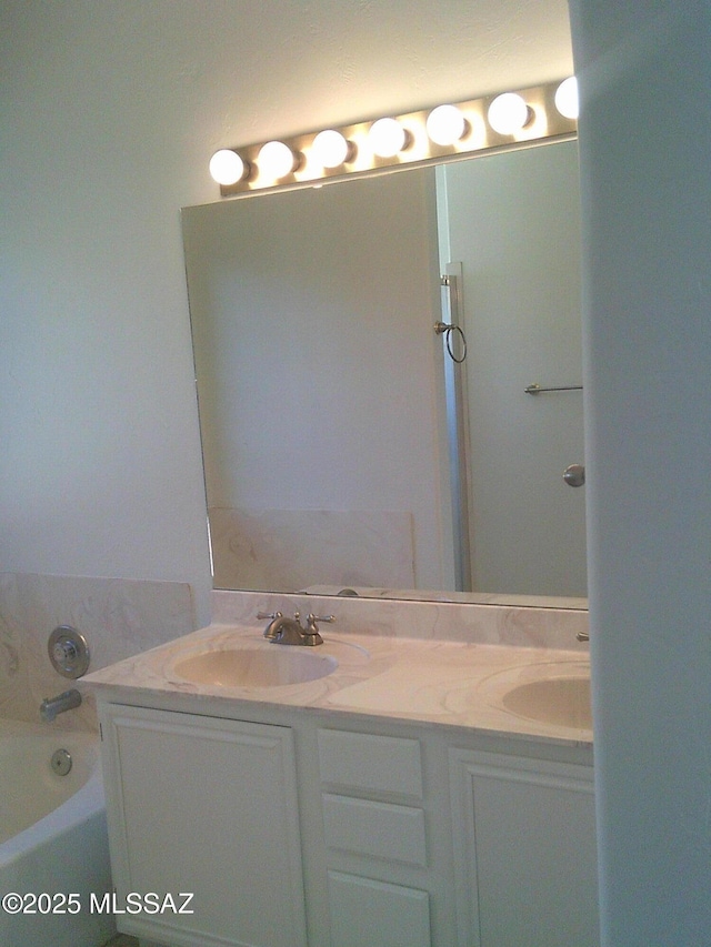 bathroom with vanity and a bathtub