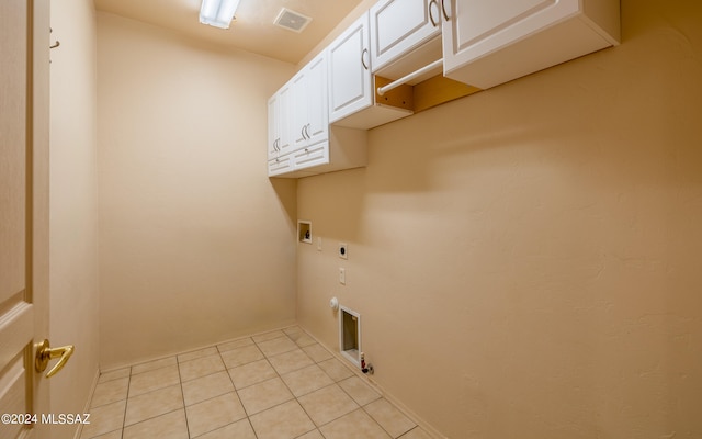 washroom with hookup for a gas dryer, cabinets, light tile patterned floors, electric dryer hookup, and washer hookup