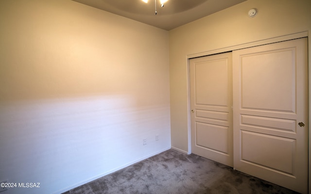 unfurnished bedroom featuring a closet and carpet